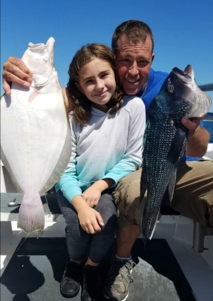 Private fishing charter Long Island — family group with catch at Point Lookout dock after Super Hawk trip